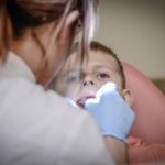 young boy getting a tooth pulled out