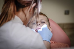 young boy getting a tooth pulled out