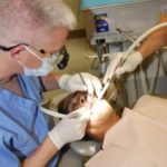 Dentist cleaning a patient's mouth