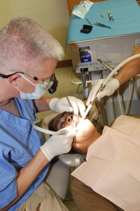 Dentist cleaning a patient's mouth